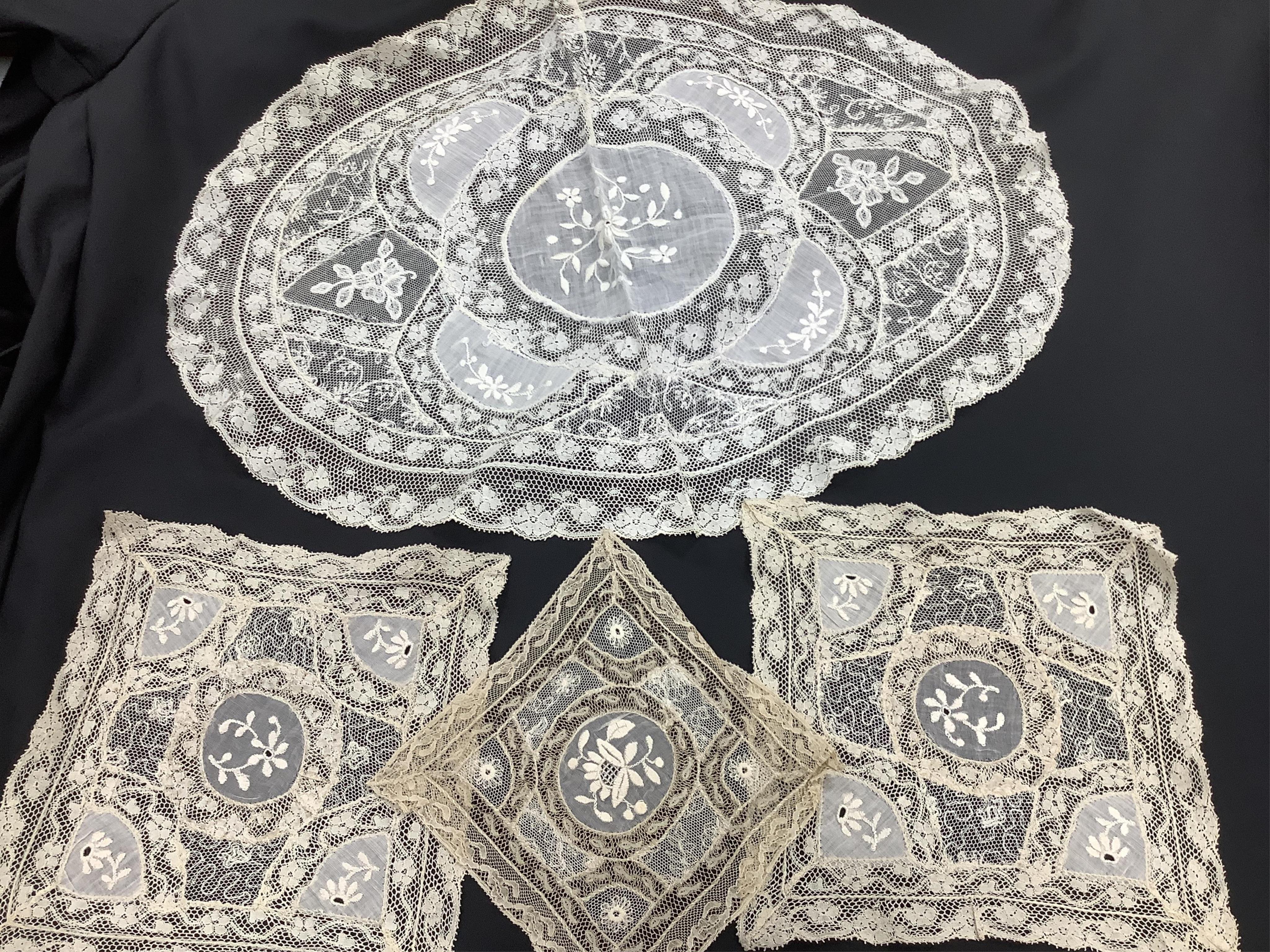 A late 19th / early 20th century circular Normandy lace table cover, with five similar smaller lace mats: all patch worked together from hand bobbin and hand needle laces, possibly part of a wedding trousseau. larger clo